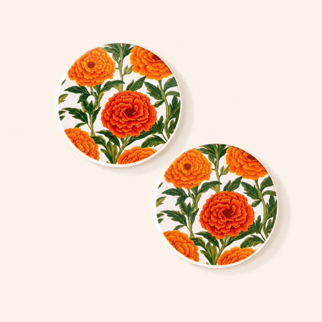 Diatom coaster featuring original artwork of vibrant marigold flowers.